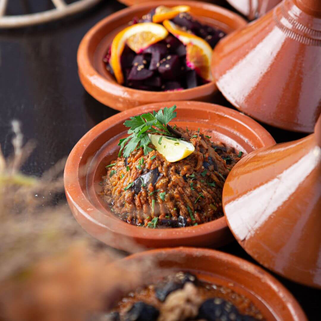 Selection of Moroccan desserts including baklava and mint tea-flavored cakes at Bedouin Agafay Hotel